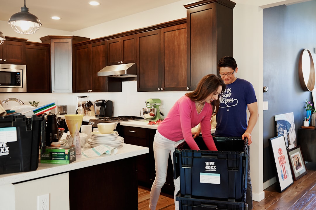 woman-in-pink-long-sleeve-shirt-standing-beside-kitchen-sink-kepwoquuf3k